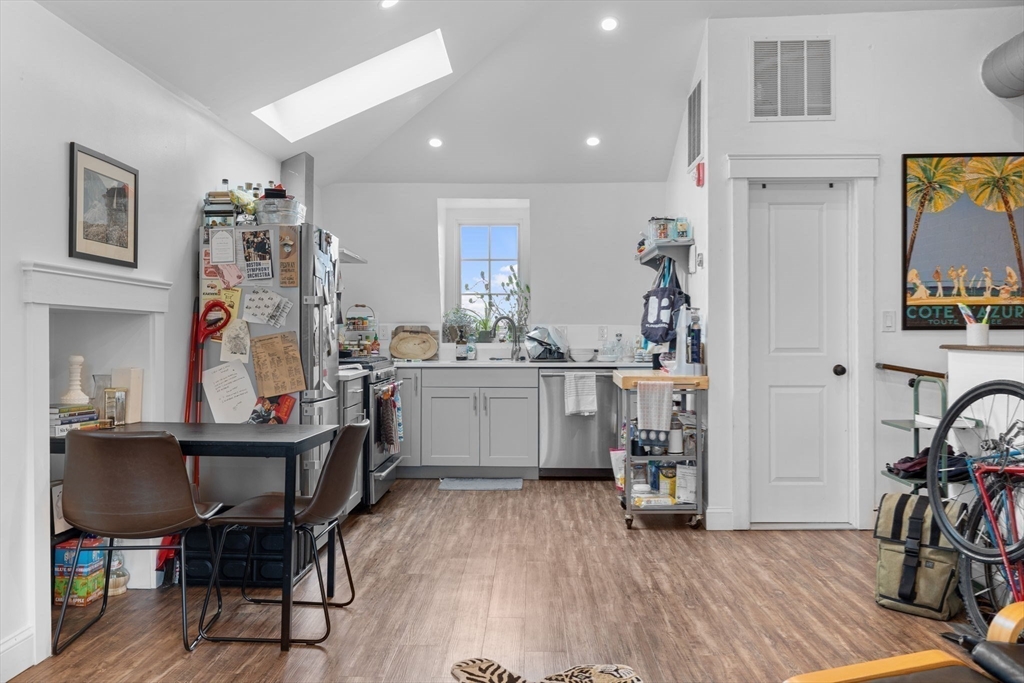 105 Broadway, Unit 3 Chelsea, MA 02150 - Photo 5 of 14 a view of a workspace with furniture and a kitchen