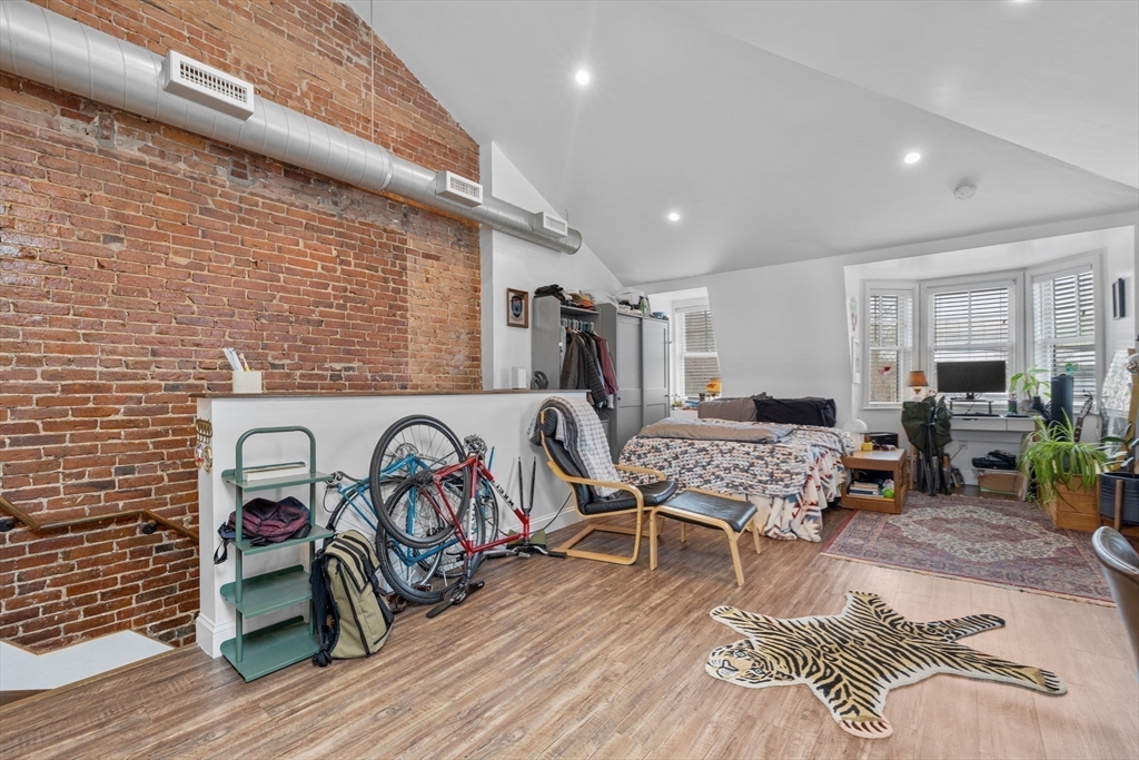 105 Broadway, Unit 3 Chelsea, MA 02150 - Photo 9 of 14 a living room with furniture and wooden floor