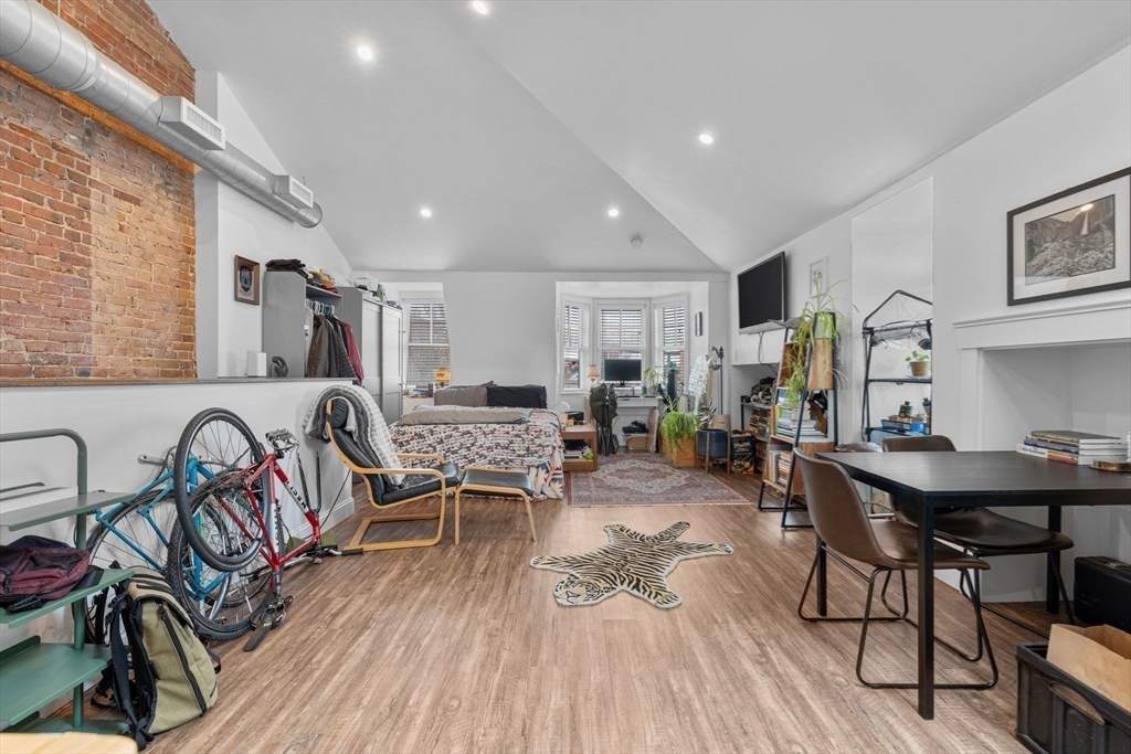 105 Broadway, Unit 3 Chelsea, MA 02150 - Photo 10 of 14 a living room with patio furniture and a wooden floor