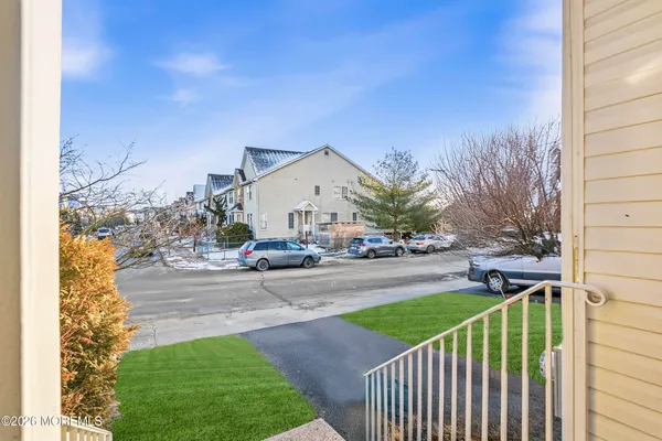 a view of a house with a yard and pathway