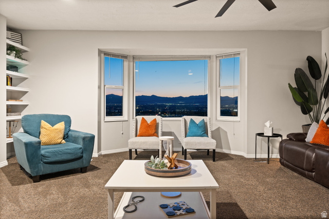 9750 Indian Ridge Drive Sandy, UT 84092 - Photo 2 of 40 Bay window with multi-paned windows featuring a mountain and city lights backdrop