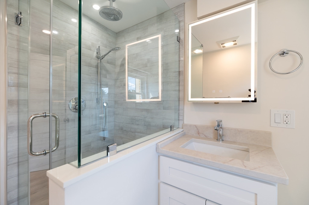 10 Fremont Street Gloucester, MA 01930 - Photo 24 of 37 a bathroom with a shower sink and mirror