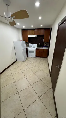 a living room with couches and kitchen view