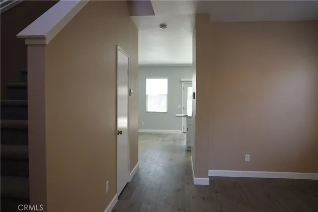 a view of a room with wooden floor