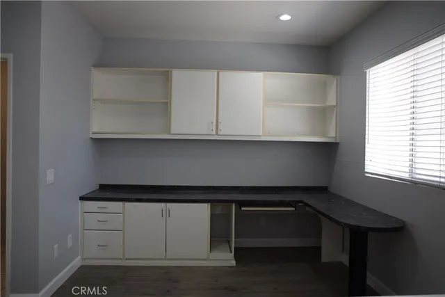 a cabinet with white cabinets and a wooden floors