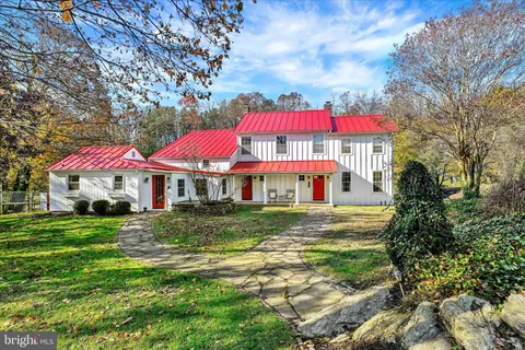 a view of a house with yard and sitting area