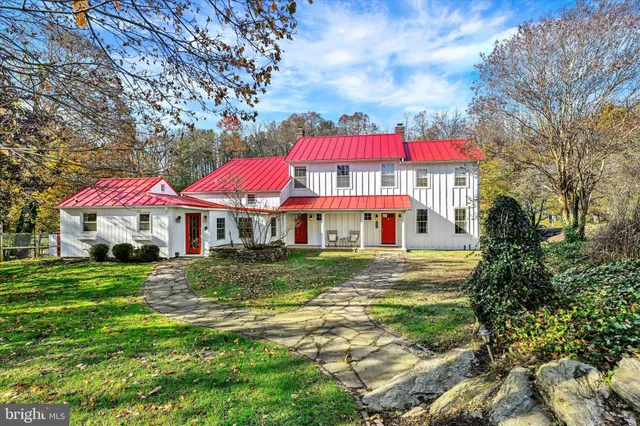 a view of a house with yard and sitting area
