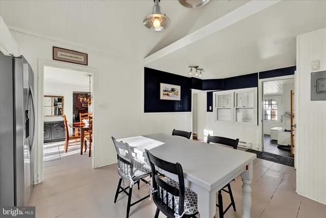 a view of a dining room with furniture and chandelier