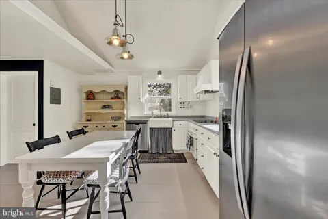 a kitchen with stainless steel appliances kitchen island granite countertop a sink and cabinets