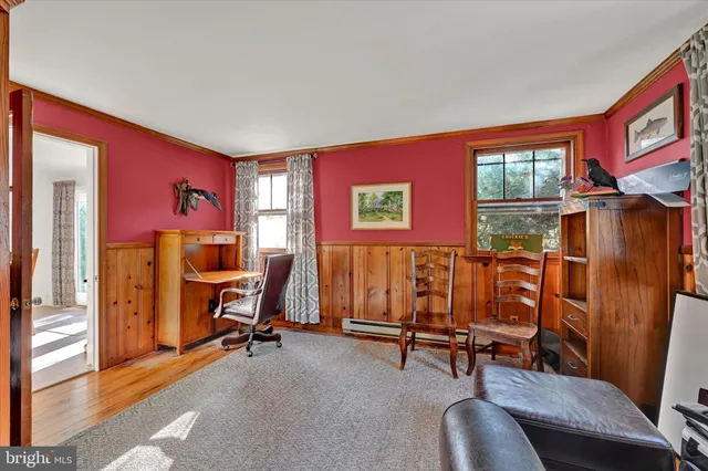 a view of a livingroom with workspace and a window