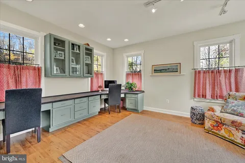 a room with furniture pool table and windows