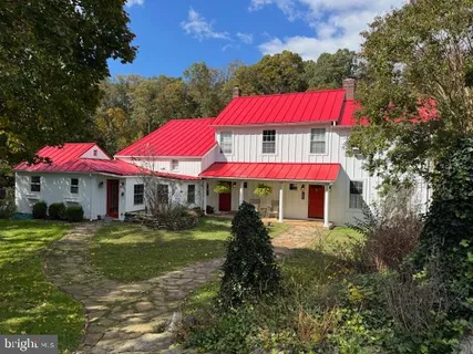 a view of a house with sitting area and garden