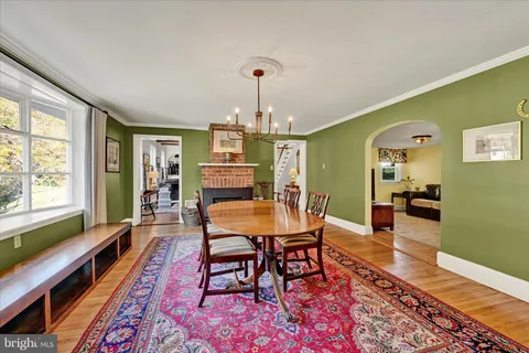 a dining room with furniture and wooden floor