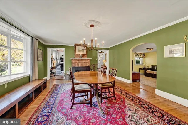 a dining room with furniture and wooden floor
