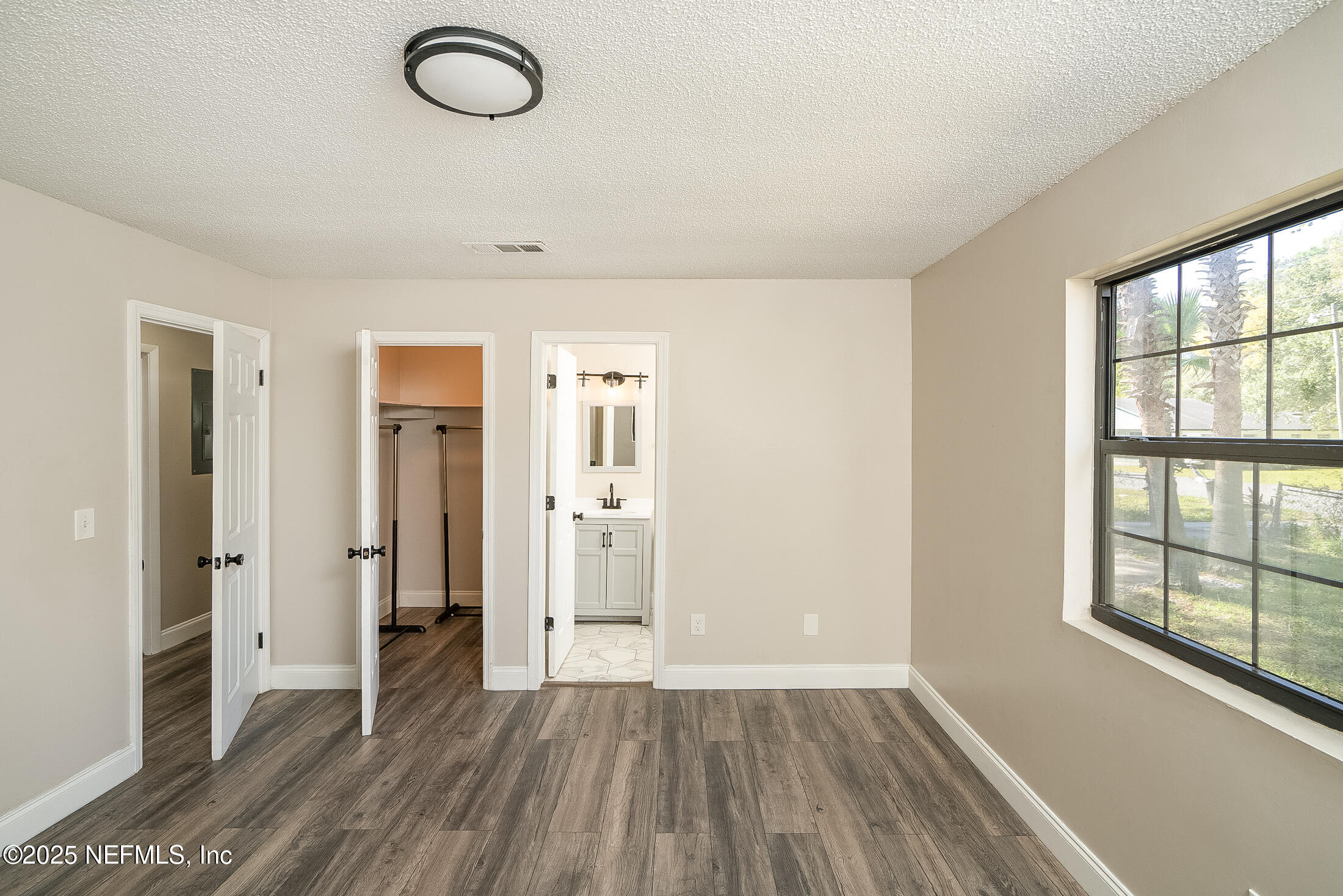 1131 Butler Avenue St. Augustine, FL 32084 - Photo 13 of 15 an empty room with wooden floor and windows