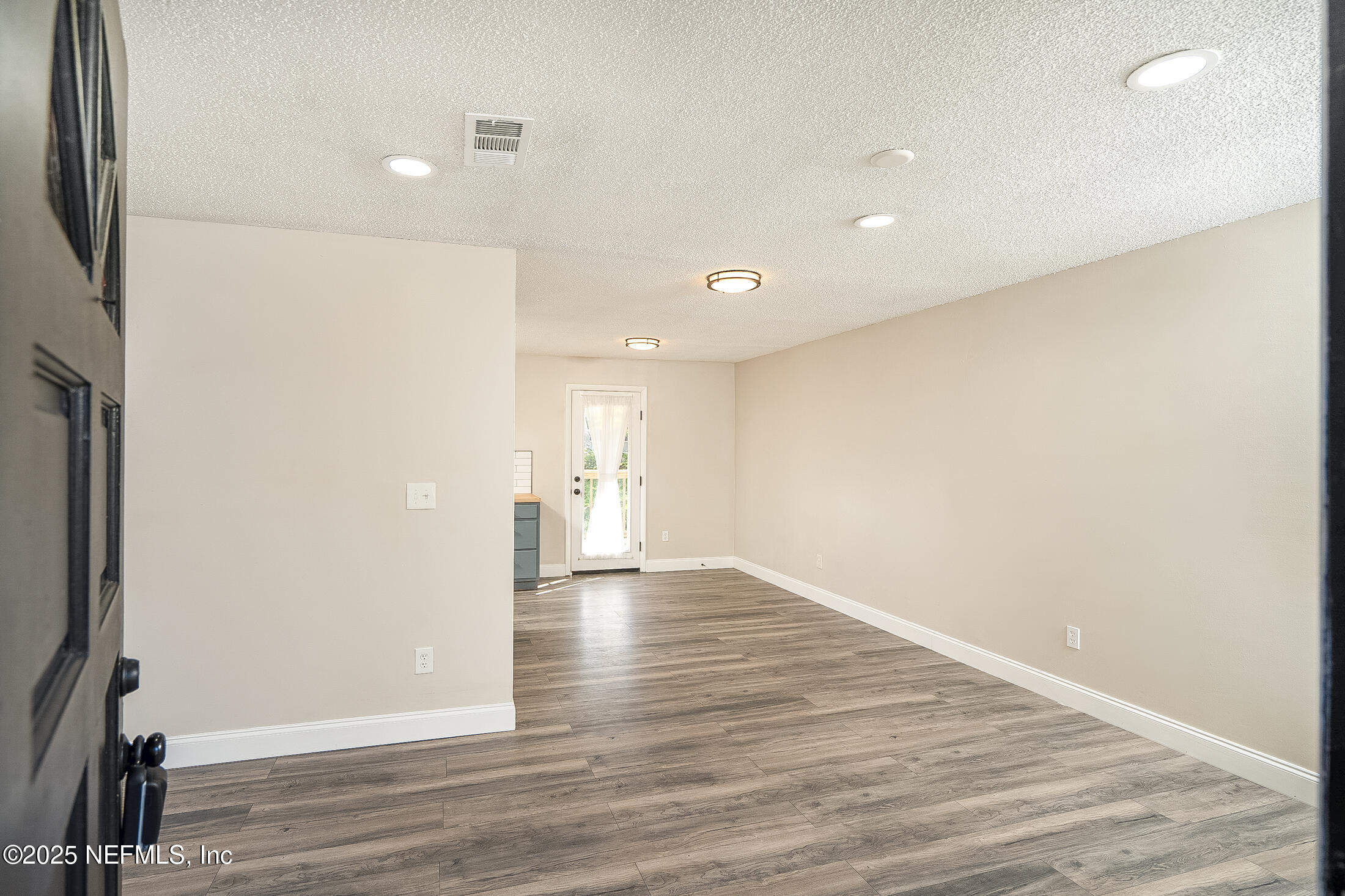 1131 Butler Avenue St. Augustine, FL 32084 - Photo 3 of 15 a view of empty room with wooden floor and fan