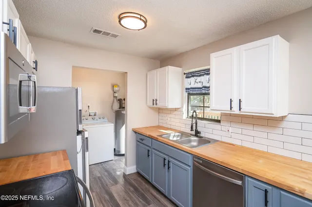 a kitchen with stainless steel appliances granite countertop a sink and cabinets