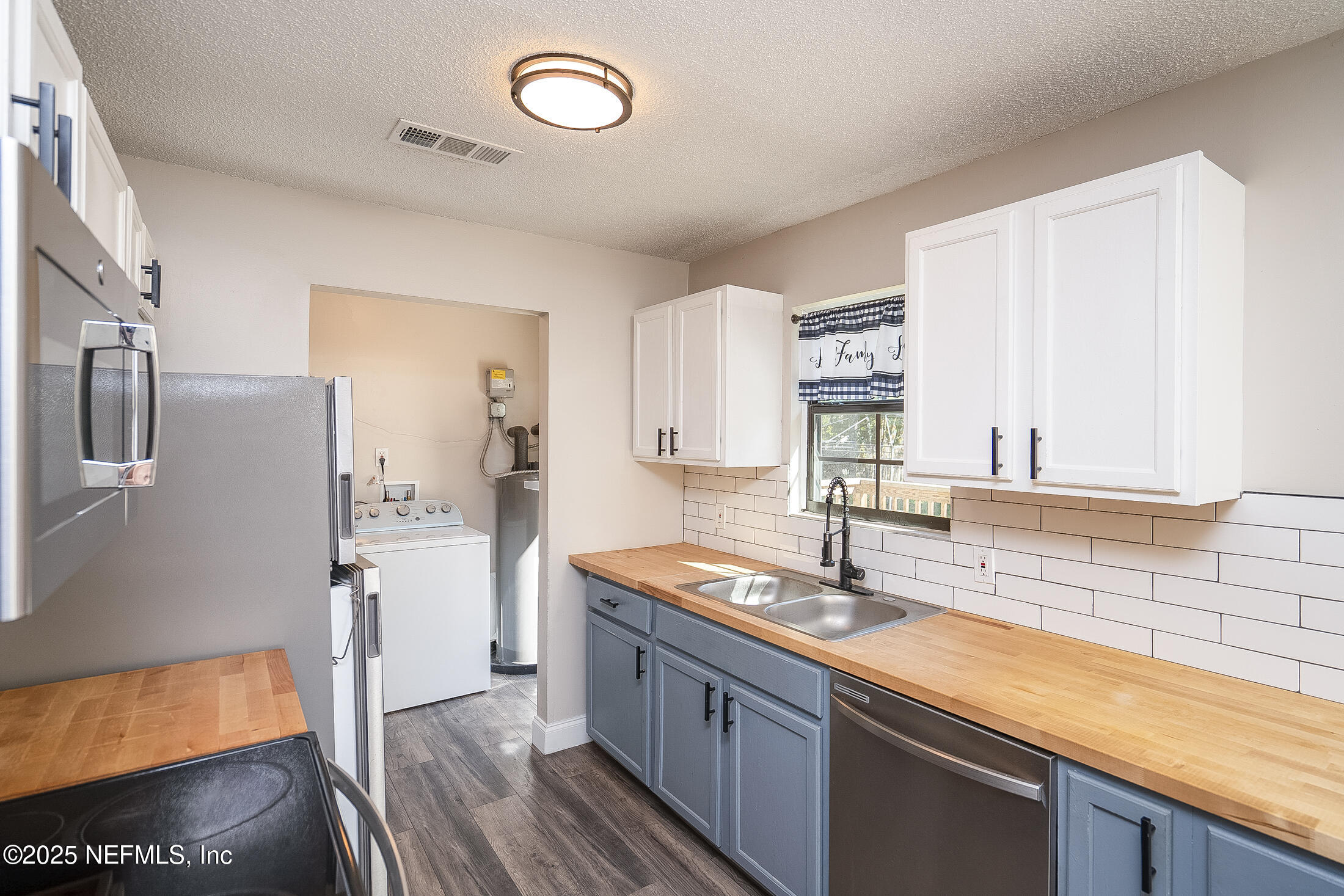 1131 Butler Avenue St. Augustine, FL 32084 - Photo 5 of 15 a kitchen with stainless steel appliances granite countertop a sink and cabinets