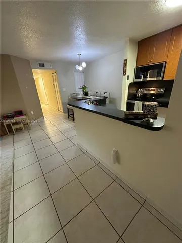 a view of a fountain in front of a yard with a fountain