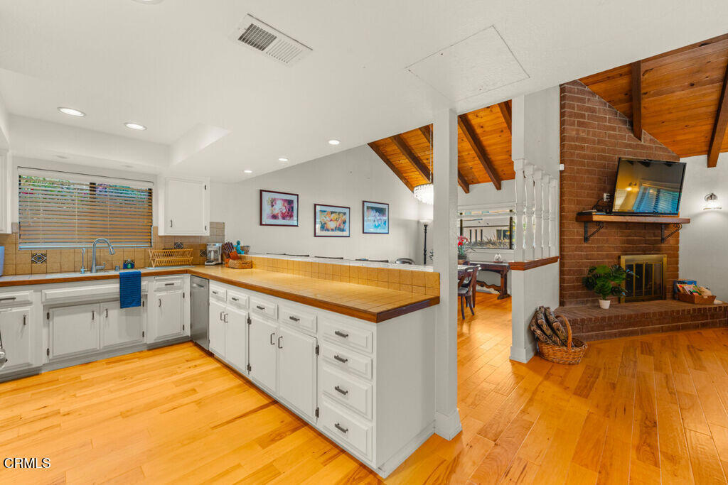 5003 Island View Street Oxnard, CA 93035 - Photo 12 of 30 a kitchen with stainless steel appliances granite countertop a sink and cabinets