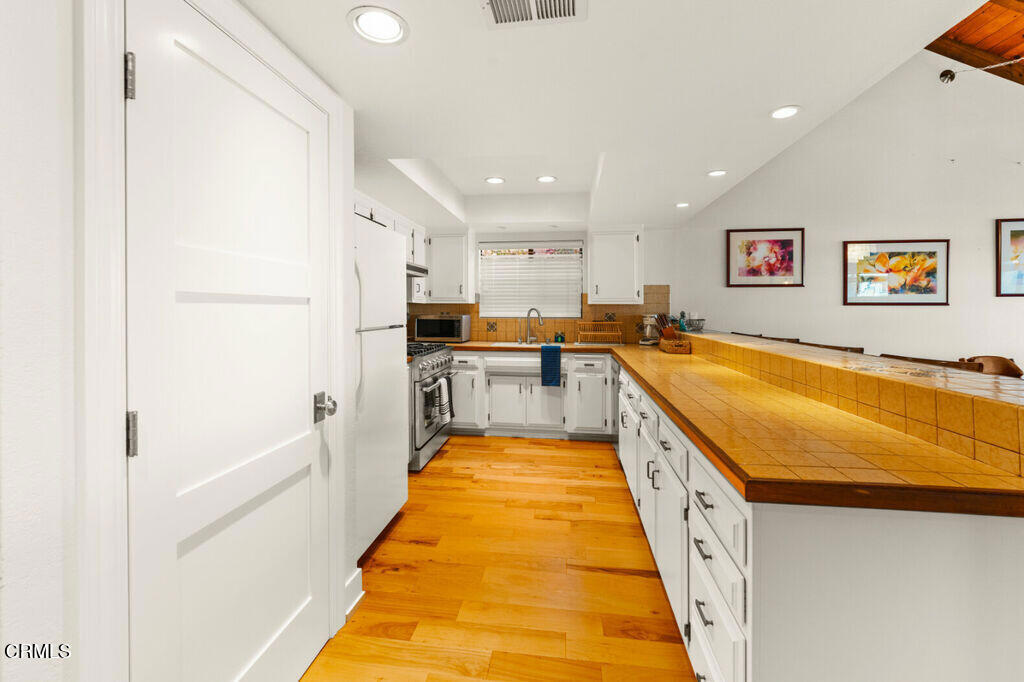 5003 Island View Street Oxnard, CA 93035 - Photo 13 of 30 a large white kitchen with a large window