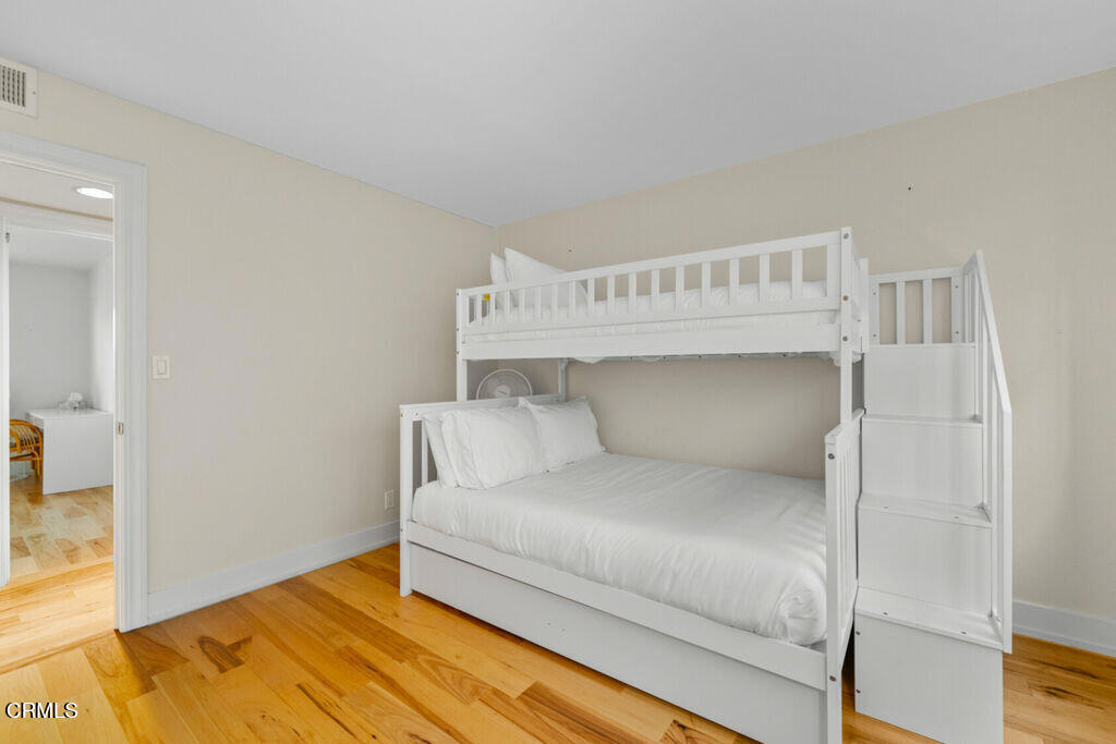 5003 Island View Street Oxnard, CA 93035 - Photo 16 of 30 a bedroom with a bed and wooden floor