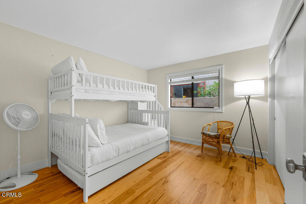5003 Island View Street Oxnard, CA 93035 - Photo 17 of 30 a bedroom with a bed a chair and potted plant on the table