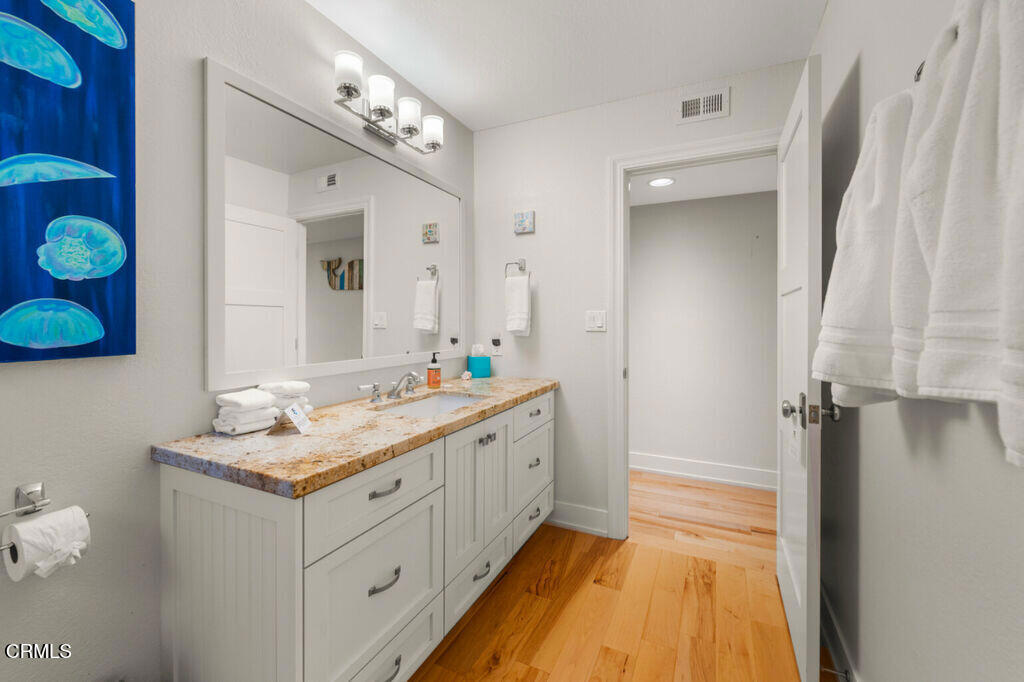 5003 Island View Street Oxnard, CA 93035 - Photo 18 of 30 a bathroom with a granite countertop sink and a mirror
