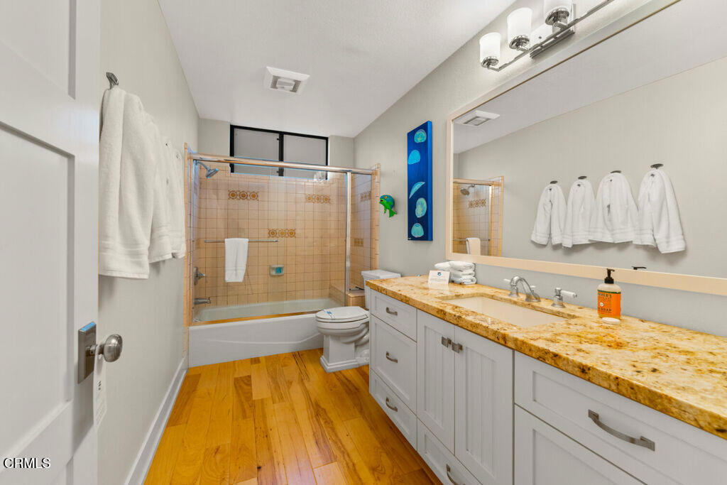5003 Island View Street Oxnard, CA 93035 - Photo 19 of 30 a bathroom with a granite countertop sink mirror toilet and bathtub