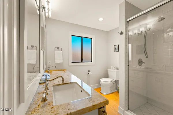 a bathroom with a sink toilet and shower