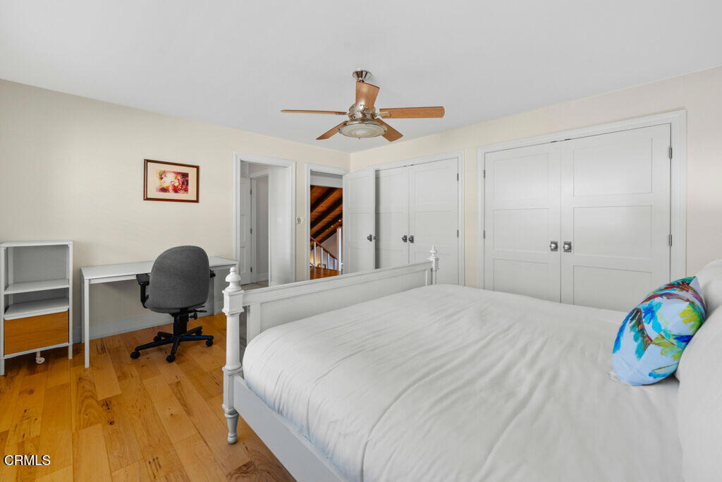 5003 Island View Street Oxnard, CA 93035 - Photo 23 of 30 a bedroom with a bed and a chandelier