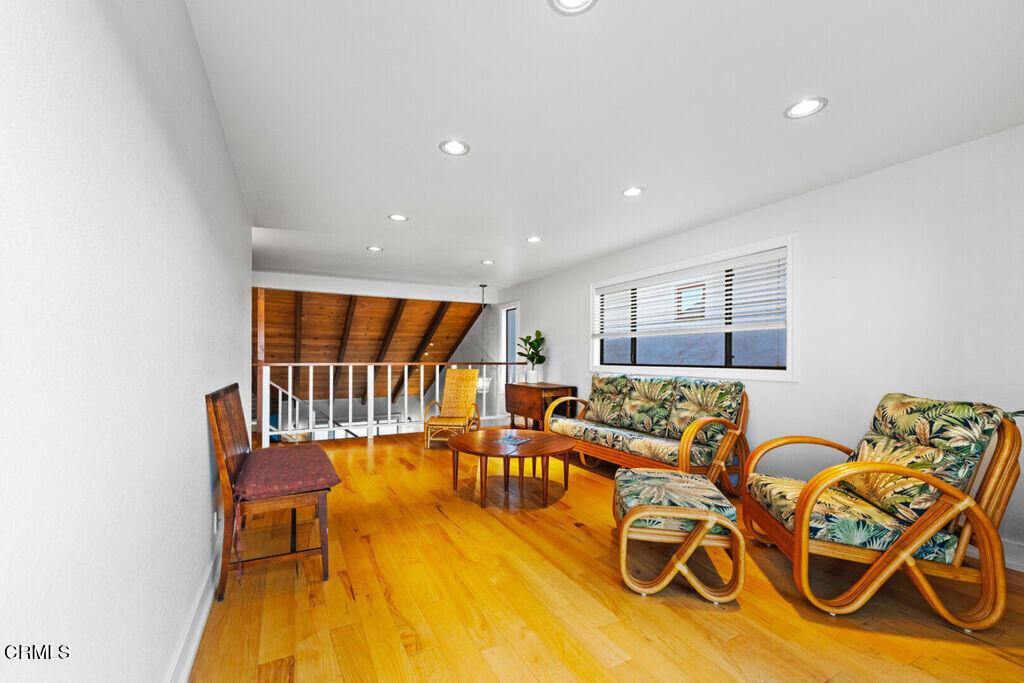 5003 Island View Street Oxnard, CA 93035 - Photo 27 of 30 a living room with furniture and a table with wooden floor