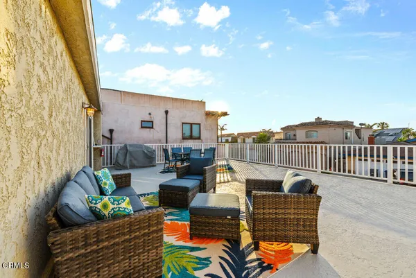 a balcony with furniture and rug