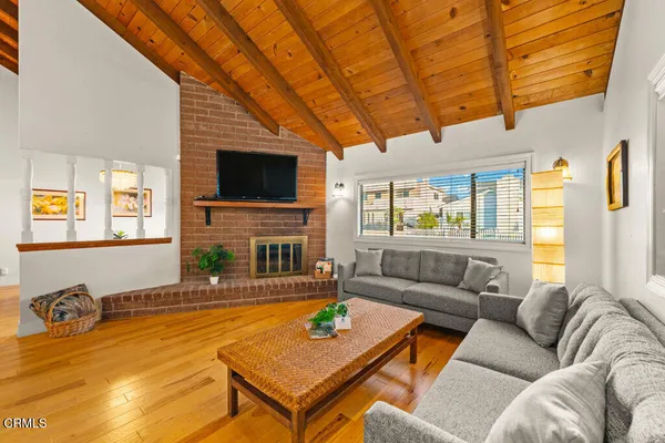 a living room with fireplace furniture and a flat screen tv