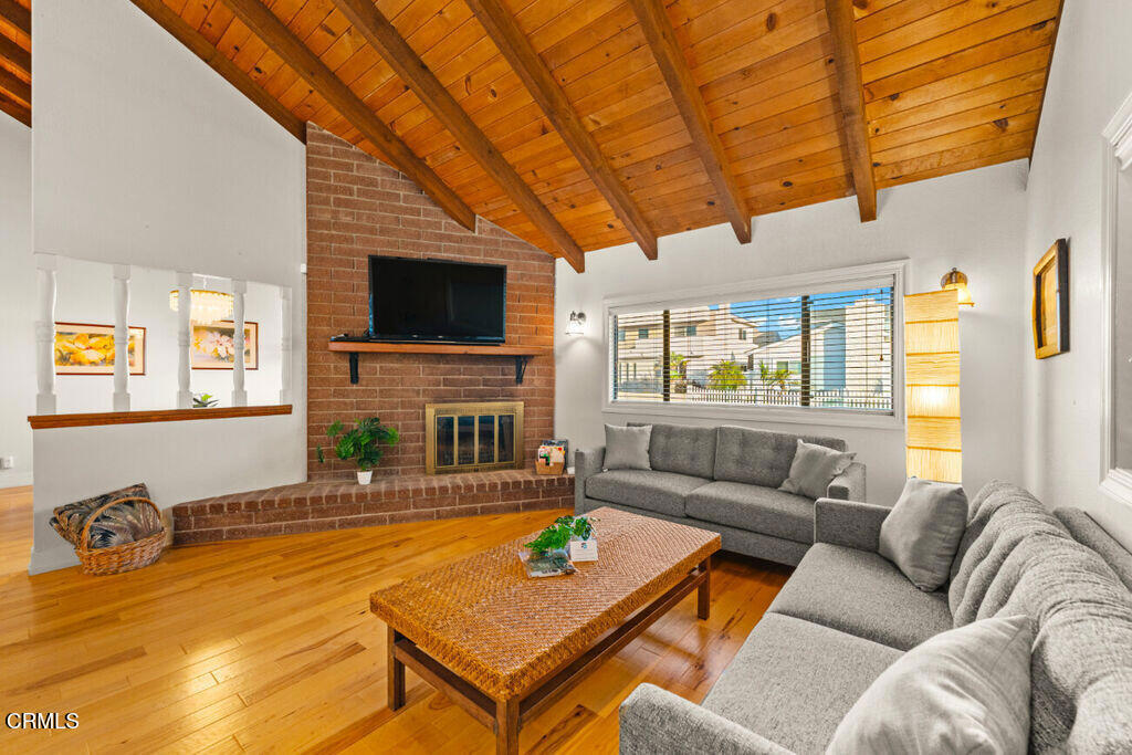 5003 Island View Street Oxnard, CA 93035 - Photo 7 of 30 a living room with fireplace furniture and a flat screen tv