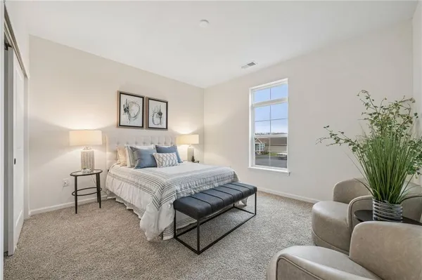a bedroom with two beds and a potted plant