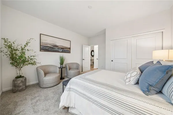 a bedroom with a bed and a lamp