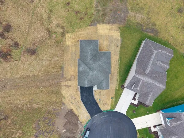 an aerial view of a house with big yard