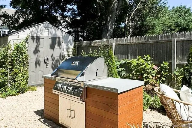 a view of outdoor kitchen and seating area