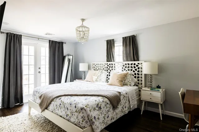 a bedroom with a large bed and a chandelier