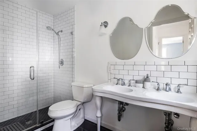 a bathroom with a toilet sink and mirror