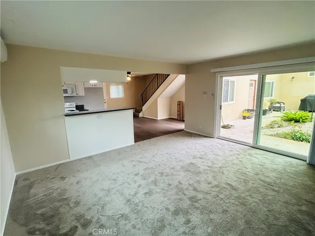 en empty room with a fireplace and entryway