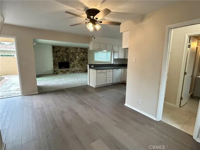 a view of living room with a fireplace and wooden floor