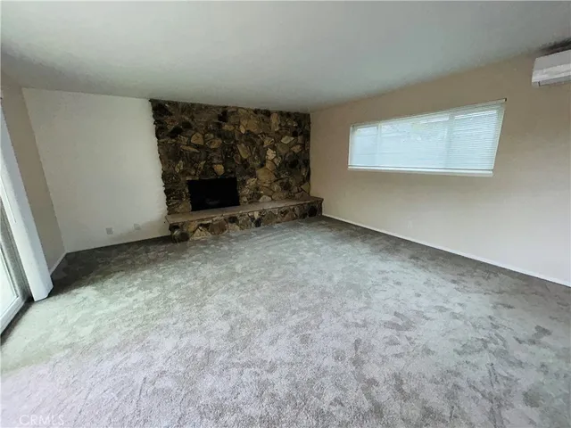 an empty room with a fireplace
