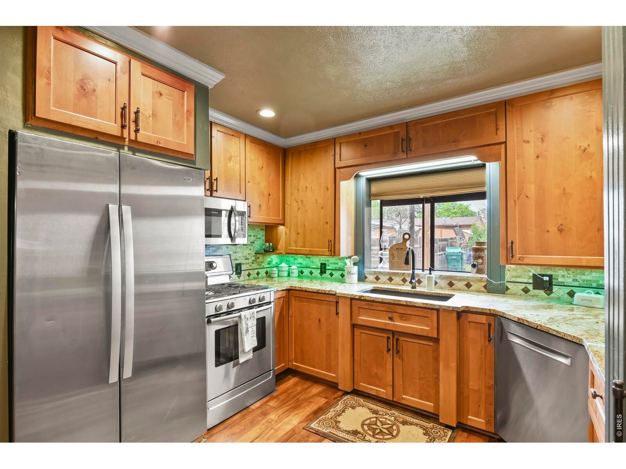 417 2nd Street Fort Lupton, CO 80621 - Photo 5 of 24 a kitchen with a sink refrigerator and window