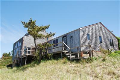 225 Sparrow Road Eastham, MA 02642 - Photo 7 of 11 a backyard of a house with table and chairs