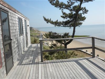 225 Sparrow Road Eastham, MA 02642 - Photo 8 of 11 a view of a balcony with wooden floor and iron fence