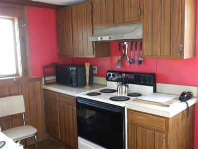 225 Sparrow Road Eastham, MA 02642 - Photo 9 of 11 a kitchen with a stove a sink and a microwave