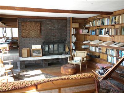 225 Sparrow Road Eastham, MA 02642 - Photo 10 of 11 a living room with lots of furniture and a book shelf