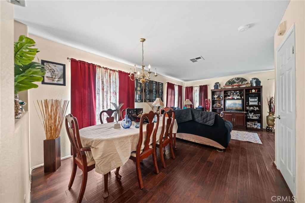 4475 Willowglen Way Hemet, CA 92545 - Photo 11 of 33 a view of a dining room with furniture and wooden floor